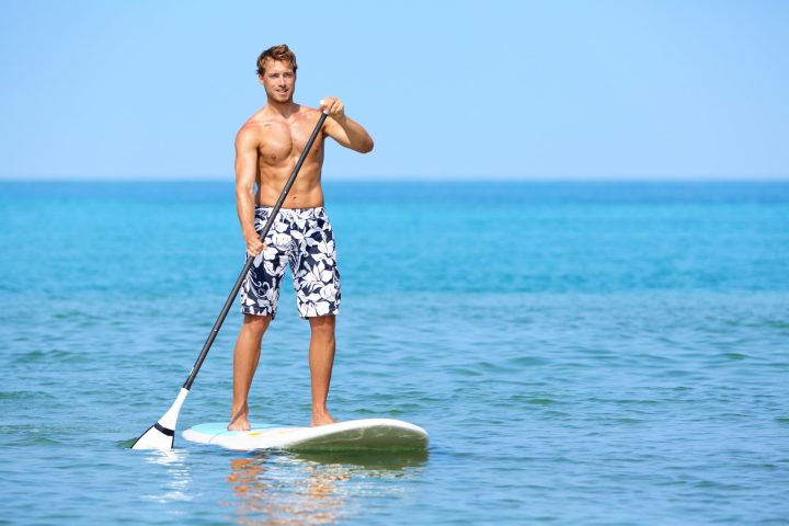 a man on a surf board on a body of water