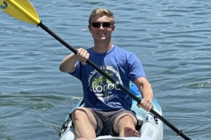 a man rowing a boat in a body of water